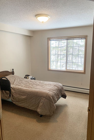 Independent living apartment bedroom at Good Samaritan Society - Hidewood Estates in Clear Lake, South Dakota.
