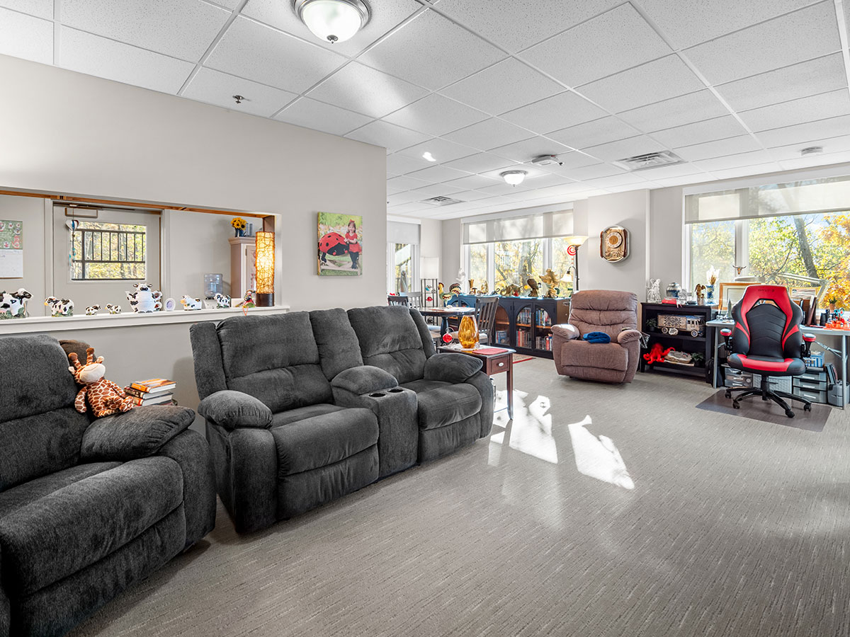 Large open concept living room with natural light and a spectacular view for independent living residents at Good Samaritan Society - Davenport in Davenport, Iowa.