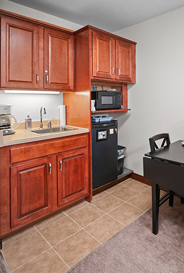 Kitchenette with sink, microwave and mini fridge in Crane Meadows Assisted Living apartment at Good Samaritan Society - Grand Island Village