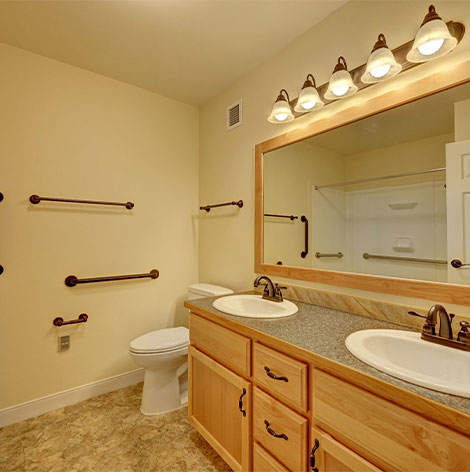 Assisted living apartment bathroom with walk-in shower at Good Samaritan Society - Loveland Village in Loveland, Colorado.