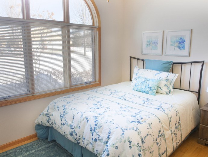 Spacious naturally light twin home master bedroom at Good Samaritan Society - Prairie Creek Village in Sioux Falls, South Dakota.