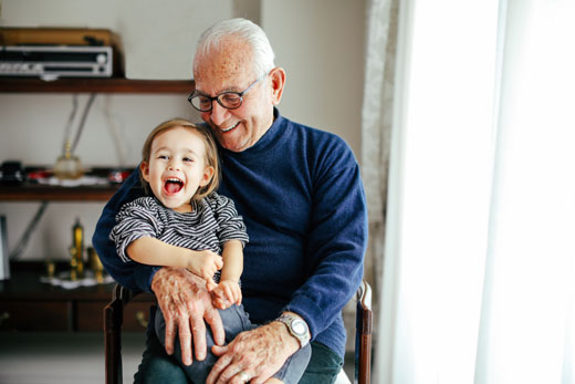 Grandpa with a grandkid on his lap.