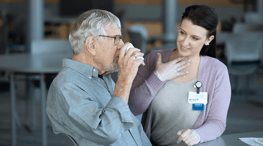 Female speech therapist working with a older male patient