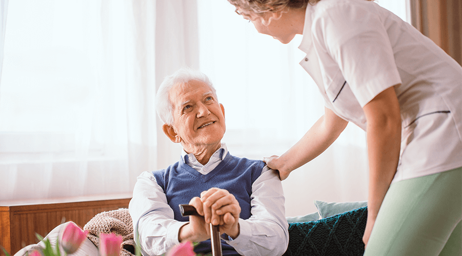Senior male smiling up at the staff member
