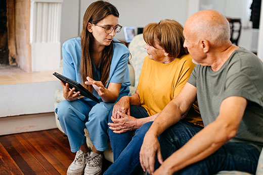 A nurse teaching a couple about their healthcare options.