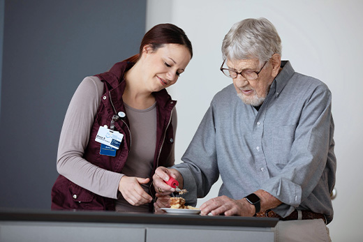 Older gentleman working with an occupational therapist on hand eye coordination by picking up a piece of pie at Good Samaritan Society.