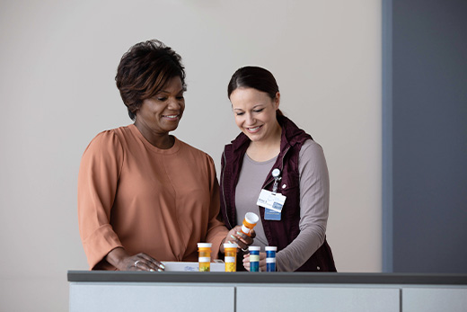 Senior woman working with an occupational therapist on opening medication bottles at Good Samaritan Society.