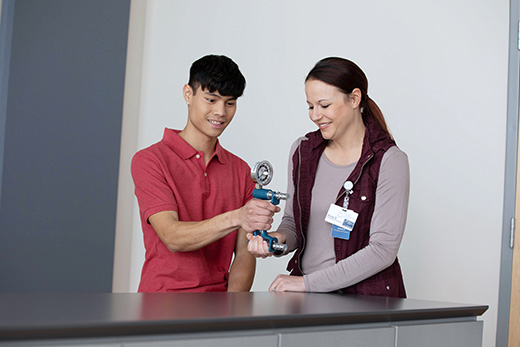 Occupational therapist at Good Samaritan Society working with a patient on strength.