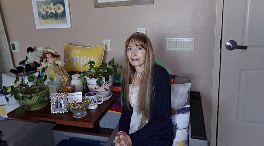 Candace Frohlich a resident at Good Samaritan Society - Sunset Drive in Mandan, North Dakota smiling at the camera.