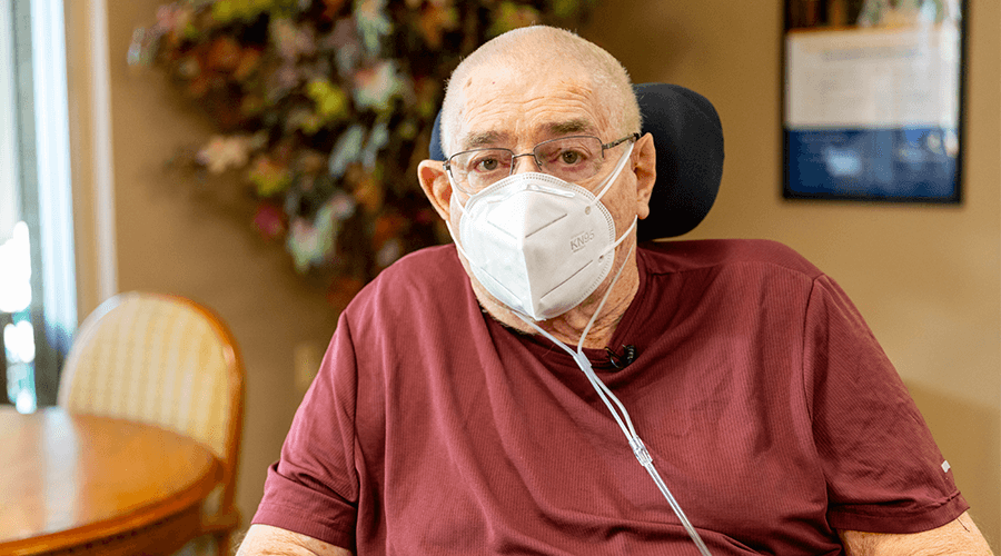 Gordy Lovell wearing a mask while sitting down