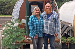 Tracy Joscelyn and Red Showers, onsite managers, stand outside their hut. As members of the program, they now help manage the site.